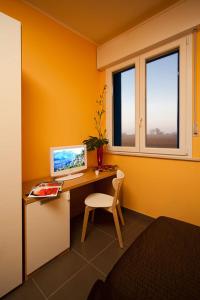 Zimmer mit einem Schreibtisch und einem Computer darauf in der Unterkunft Hotel Ponte in Colorno