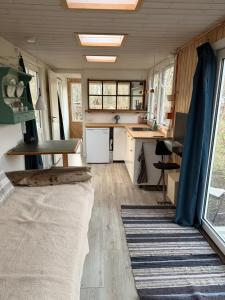a tiny house with a kitchen and a living room at Tiny house close to Copenhagen in Nybølle +20 photos