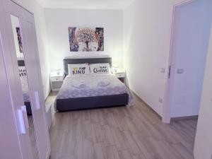 a small bedroom with a bed and two night stands at Holidays Apartment in Cagliari