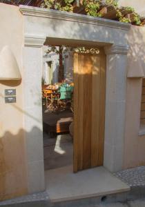 a wooden door leading into a patio with a table at Agapi Holiday House in Sívas