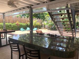 eine Glasbar auf einer Terrasse mit Stühlen in der Unterkunft TRIBE by Aforetime in Taling Ngam Beach