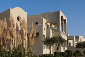 a building with trees in front of it at The Majestic Hotel in Fira