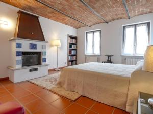 a bedroom with a bed and a fireplace at Villa Floro in Azzano d'Asti