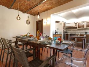 a dining room with a wooden table and chairs at Villa Floro in Azzano d'Asti
