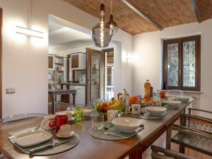 a kitchen with a large wooden table with food on it at Villa Floro in Azzano d'Asti +25 photos