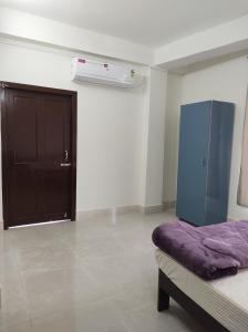 a bedroom with a purple bed and a door at Windfall Homestay in Dimapur +2 photos