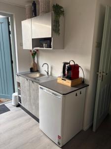 a kitchen with a sink and a counter top at Waves in De Koog