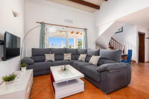 a living room with a couch and a table at Villa Vientosol by Villa Plus in Cala en Forcat