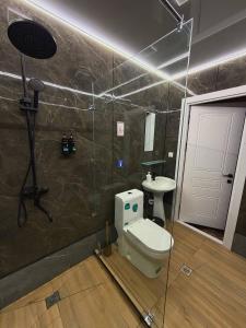 a bathroom with a toilet and a sink at TWENTY Hostel in Samarkand