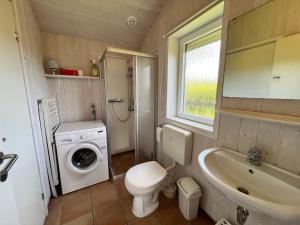 a bathroom with a toilet sink and a washing machine at Ferienhaus Strandpark 13 in Grömitz