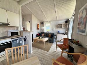 a kitchen and living room with a couch and a table at Ferienhaus Strandpark 13 in Grömitz