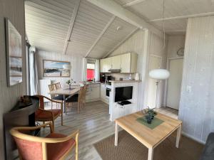 a kitchen and living room with a table and chairs at Ferienhaus Strandpark 13 in Grömitz