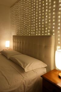 a bedroom with a bed with lights on the wall at Rifugio Baita Belvedere in Champoluc