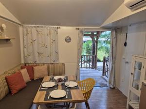 a living room with a table and a couch at Glamour Pakoštane Mobile Home in Pakoštane