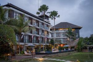 a hotel with a pool in front of a building at Plataran Ubud Hotel & Spa in Ubud