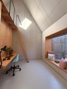 an attic room with a desk and a window at 44Møen in Askeby