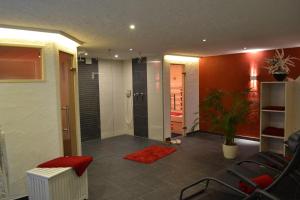 a bathroom with a shower with a red wall at Hotel Forsthaus in Winterberg
