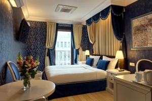 a hotel room with a bed and a table at SleepWalker Boutique Suites in Wrocław