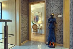 a statue of a woman in a blue dress in a hallway at SleepWalker Boutique Suites in Wrocław