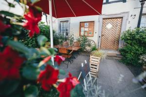 a patio with a table and chairs and an umbrella at Gästehaus Korf in Unkel