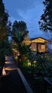 a building with a fence and a walkway at night at The Bataran Cabin in Gitgit