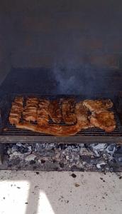 a grill with a bunch of meat on it at Kuća za odmor Bela Goranci in Mostar