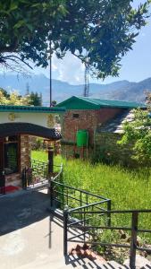 a building with a fence in front of it at Tungnath View Homestay in Sari