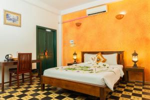 a bedroom with a bed and a table and a desk at Golden Banana Residence in Siem Reap +51 photos