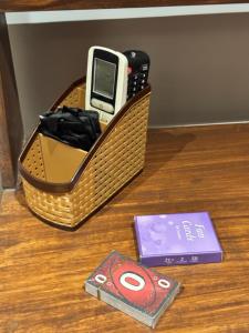 a cell phone in a basket on top of a table at Shagun Stays in Greater Noida