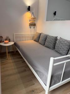 a large bed in a room with a table at The Small apartment Papa Nero Pelion in Agios Ioannis Pelio