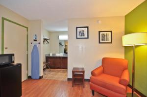 a living room with a chair and a dress at Country Hearth Inn & Suites Marietta in Atlanta