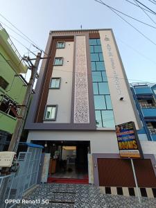 a building with a sign in front of it at Sri Datta Paduka Nivas in Pithāpuram