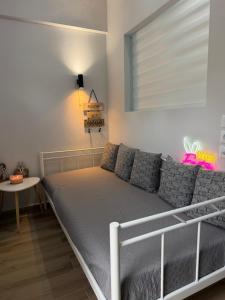 a bedroom with a bed and a couch at The Small apartment Papa Nero Pelion in Agios Ioannis Pelio