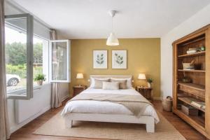 a bedroom with a bed and a large window at Élégance et nature votre refuge entre mer et forêt in Vielle-Saint-Girons +23 photos