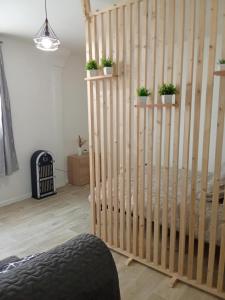 a wooden staircase in a room with potted plants at Le cocon en Champagne in Avize