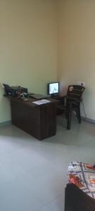 an office with a desk with a computer and a chair at jAYESH PALACE in Loni Kālbhor