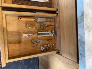 a wooden drawer with scissors in a cabinet at The Bataran Cabin in Gitgit