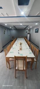 a large conference room with a long table and chairs at Nuva Hotel in Islamabad