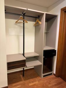 a walk in closet with white shelves and a door at Hotel Baia Flaminia in Pesaro
