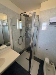 a bathroom with a shower and a toilet at Hotel Baia Flaminia in Pesaro