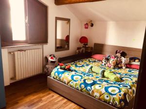 a bedroom with a bed with stuffed animals on it at Casa Alma in Cogliate