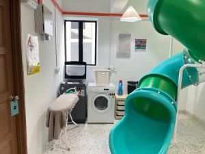 a bathroom with a washing machine and a washer at Puzzle House in Taiping