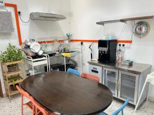 a kitchen with a table and a table and chairs at Puzzle House in Taiping