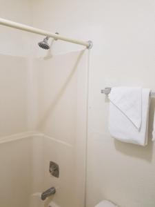 a bathroom with a toilet and a white towel at Masters Inn I-26 in Cayce