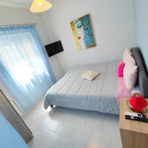 a small bedroom with a bed and a window at Nature House Vlatos in Vlátos