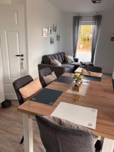 a living room with a table and a couch at Ferienwohnung Möwentöne in Bensersiel +21 photos
