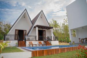 a house with a swimming pool in front of it at King coco villa in Tangalle