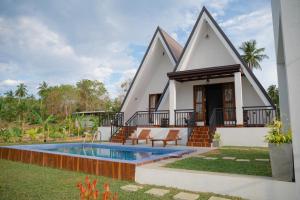 a house with a swimming pool in front of it at King coco villa in Tangalle