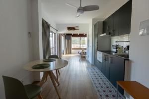 a kitchen with a table and chairs in a room at Seamount, studio 3 mins from Tamariu beach in Tamariu