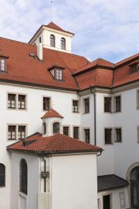 a large white building with a red roof at Augustine Hotel, Prague in Prague